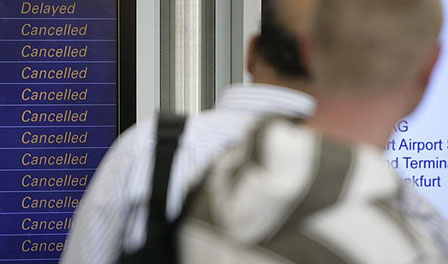 Passengers look at screens showing the flight schedules at Frankfurt airport April 16, 2010. A huge ash cloud from an Icelandic volcano spread out across Europe on Friday causing air travel chaos on a scale not seen since the September 11 attacks.